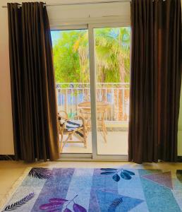 a room with a sliding glass door with a view of a patio at Moka Gust House in Luxor