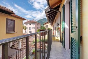 a balcony with a view of some buildings at Le Coccinelle Home in Mandello del Lario