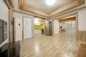 a large room with wooden floors and a kitchen at Boryeong Daecheon Sun and Moon Pension in Boryeong