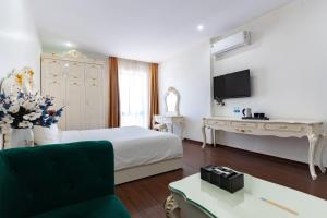 a hotel room with a bed and a desk at Grand Hill Hotel & Apartment in Hai Phong