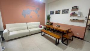 a living room with a couch and a table at 拼圖民宿 in Jinning
