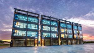a large building with many windows at dusk at Gangneung Music Time Spa Pension in Gangneung