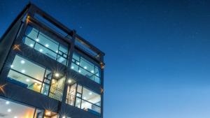 a building with many windows at night at Gangneung Music Time Spa Pension in Gangneung