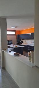 a large kitchen with a large white counter top at Foresteria Emilia in Grosotto