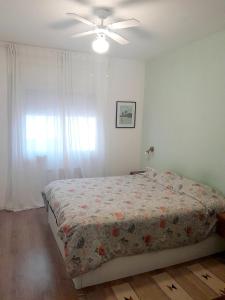 a bedroom with a bed and a ceiling fan at Vacation house in the mountains in Esparraguera