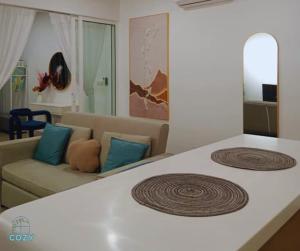 a bed in a living room with a couch at The Shore Seaview A1817 in Kota Kinabalu