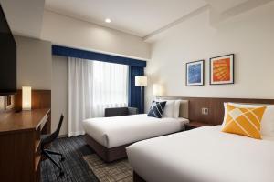 En eller flere senger på et rom på Four Points Flex by Sheraton Nagoya Station