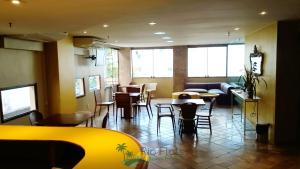 a restaurant with tables and chairs in a room at Apart Hotel Leblon Ocean in Rio de Janeiro