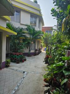 a building with a lot of plants in front of it at Asian Grand Villa in Bolpur