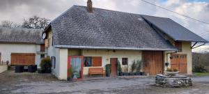 a house with a bench in front of it at Vers La Grange in Arbusigny