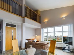 a living room with a glass table and a couch at Stunning 2BR Apt in City Centre in Belfast