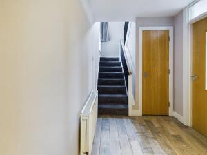 a hallway with a staircase and a stair case at Stunning 2BR Apt in City Centre in Belfast