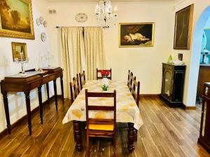 a dining room with a table and chairs and a chandelier at XL Massive Art-Filled Home in Central Area, WALK to Sliema, St Julian's in Il-Gżira +34 photos
