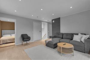 a living room with a couch and a bed at Northstay - The Arctic Pearl, Central House with 4 bedrooms and 2 bathrooms in Tromsø