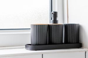 a black soap dispenser sitting on a window sill at Comfortable 2 Bedroom House in Redcar in Warrenby +50 photos