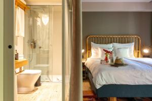 a bedroom with a bed and a bathroom with a shower at Bikini Island & Mountain Port de Soller "Adults only" in Port de Soller