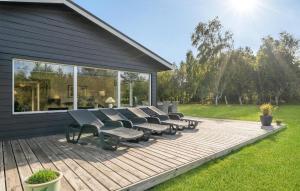 a deck with chairs and tables on a house at Holiday Home Jerup With Fireplace I in Jerup