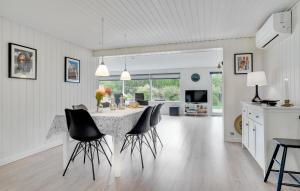 a kitchen and dining room with a table and chairs at Holiday Home Jerup With Fireplace I in Jerup