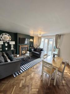 a living room with a couch and a table at Cosy Corby Getaway in Corby