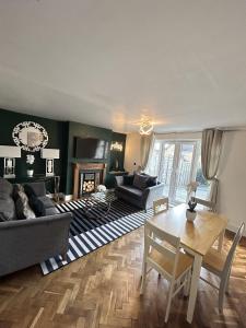 a living room with a couch and a table at Cosy Corby Getaway in Corby