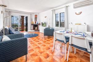 a living room with a table and chairs and a couch at F04 Bahia Playa - Apartment in Mijas Costa