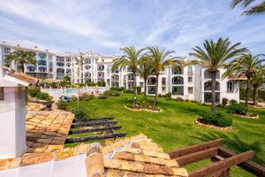 a view of a resort with palm trees and buildings at F04 Bahia Playa - Apartment in Mijas Costa