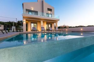 a house with a swimming pool in front of a house at Estel Residences in Chania Town