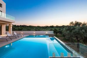 a swimming pool with a view of a house at Estel Residences in Chania Town