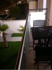 a balcony with a table and a table and chairs at Love Room Charme in Tremblay En France