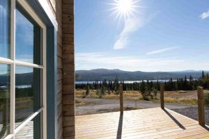 a house with a window and a view of the mountains at Ski-in/Ski-out | Sauna | WiFi | Free EV-charger in Lofsdalen