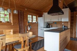 a kitchen with white cabinets and a counter in a cabin at Ski-in/Ski-out | Sauna | Engine heater in Lofsdalen