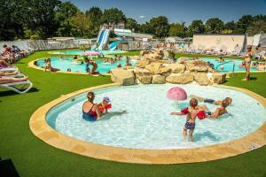 a group of people in a pool at a water park at Camping 4 étoiles - Parc aquatique - eeiagf in Damgan