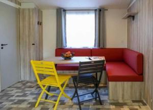 a room with a table and chairs and a couch at Camping 4 étoiles - Parc aquatique - eeiagf in Damgan +15 photos