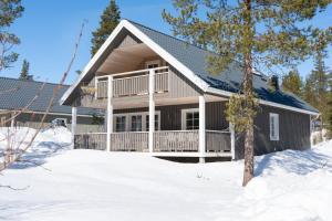 a house with a porch in the snow at Sauna cabin | Pets allowed | Engine heater in Lofsdalen