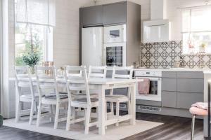 a kitchen with a white table and white chairs at Close to ski slopes | Sauna | WiFi | Terrace in Lofsdalen +6 photos