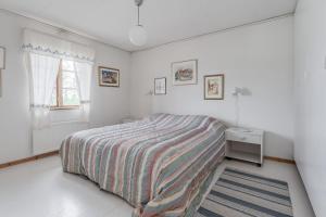 a white bedroom with a bed and a window at Ski-in/Ski-out | Wi-Fi | Sauna | Terrace | Stove in Lofsdalen