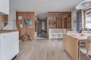 a kitchen and living room with wooden walls at Ski-in/Ski-out | Wi-Fi | Sauna | Terrace | Stove in Lofsdalen