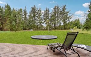 a chair sitting on a deck next to a trampoline at Casa Fortuna in Bindslev +24 photos