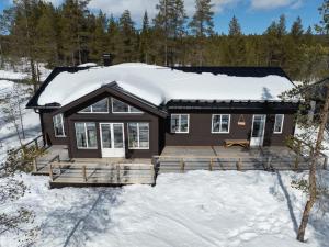 a house with a deck in the snow at Sauna | Wi-Fi | Pets allowed | Dryer in Lofsdalen