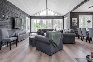 a living room with two couches and a dining room at Sauna | Wi-Fi | Pets allowed | Dryer in Lofsdalen