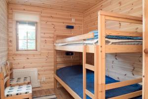 a bedroom with bunk beds in a log cabin at Sauna | Engine heater | Wood stove | Terrace in Lofsdalen