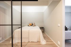a bedroom with a bed in a white room at Tuusulan Olympiatalo in Hyrylä