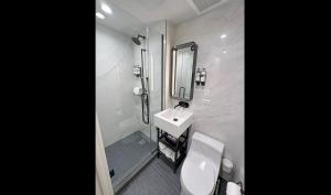 a bathroom with a sink and a toilet and a mirror at Pestana Park Avenue in New York