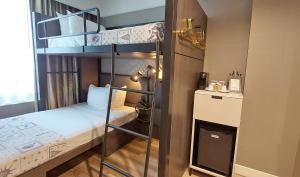 two bunk beds in a small room with a bed at Pestana Park Avenue in New York