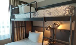 two bunk beds in a room with a lamp at Pestana Park Avenue in New York