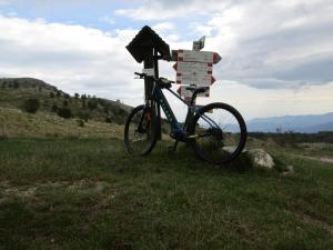 a bike parked next to a sign in a field at La dimora del castagno in Ormea