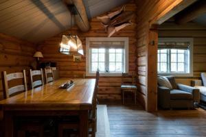 a dining room with a wooden table in a cabin at Wi-Fi | Grill | Pets allowed | Drying cabinet in Lofsdalen