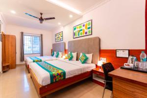 A bed or beds in a room at Treebo Regalia Comforts, 15 Mins From Abbey Waterfall