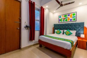 A bed or beds in a room at Treebo Regalia Comforts, 15 Mins From Abbey Waterfall