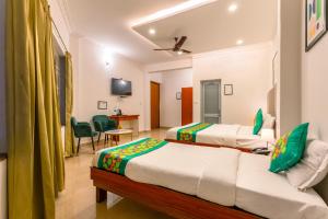 A bed or beds in a room at Treebo Regalia Comforts, 15 Mins From Abbey Waterfall